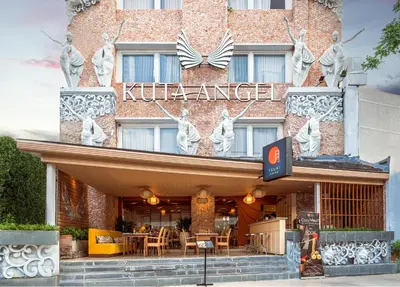 a kilt palace hotel with a sign on the front of it at Kuta Angel Hotel in Kuta