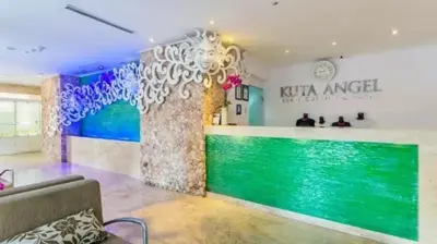 a lobby of a kiki angelica store with a bar at Kuta Angel Hotel in Kuta
