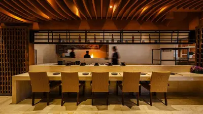 a dining room with a large table and chairs at Kuta Angel Hotel in Kuta