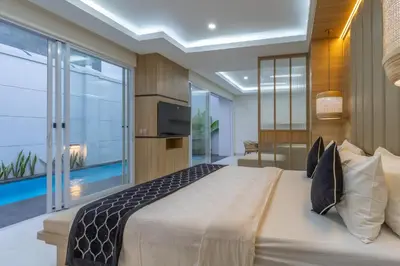 a bedroom with a large bed and a large window at Arunika Prime Villa in Seminyak