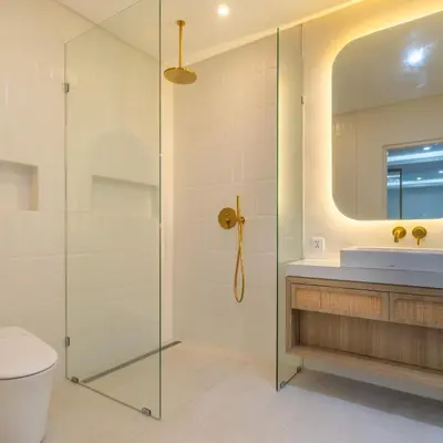 a bathroom with a shower and a toilet and a sink at Arunika Prime Villa in Seminyak