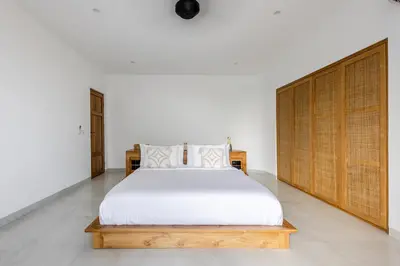 a bedroom with a large white bed in a room at Villa Harper by BaliSuperHost in Canggu