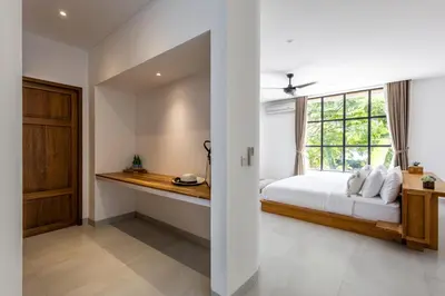 a bedroom with a bed and a window at Villa Harper by BaliSuperHost in Canggu