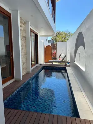 a swimming pool in the side of a house at Villa with pool Nusa Dua in Nusa Dua