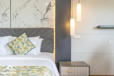 a bedroom with a bed and a side table at Villa Sila by Bukit Vista in Canggu