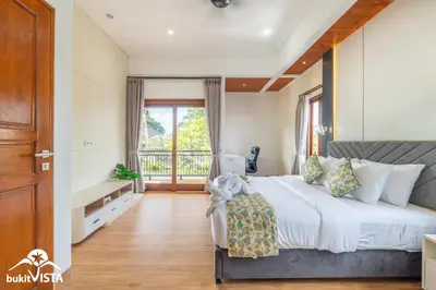 a bedroom with a large bed and a large window at Villa Sila by Bukit Vista in Canggu