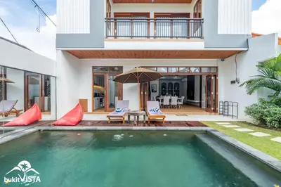 a villa with a swimming pool and a house at Villa Sila by Bukit Vista in Canggu