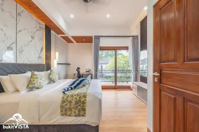 a bedroom with a large bed and a balcony at Villa Sila by Bukit Vista in Canggu