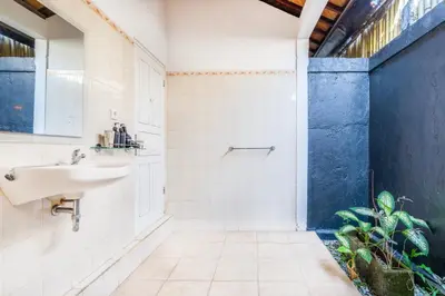 a bathroom with a sink and a shower at Villa Jasmin Seminyak in Seminyak