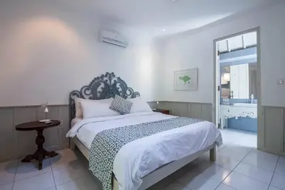 a bedroom with a large bed and a window at 2 BedRoom Villa Hideaways Seminyak in Seminyak
