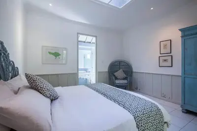 a bedroom with a white bed and two chairs at 2 BedRoom Villa Hideaways Seminyak in Seminyak