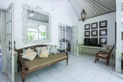 a living room with a bench and a mirror at 2 BedRoom Villa Hideaways Seminyak in Seminyak