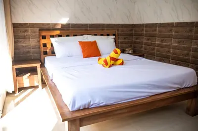 a bed with two stuffed animals sitting on top of it at Lily Villa in Seminyak