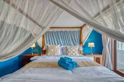 a bedroom with a bed with blue towels on it at Villa Ima in Canggu