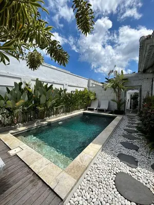 a swimming pool in the middle of a yard at Baliview homestay in Umalas