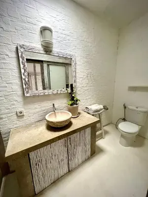 a bathroom with a sink and a toilet at Baliview homestay in Umalas