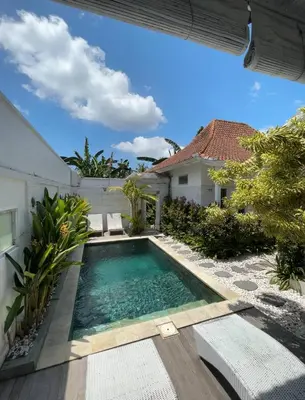 a swimming pool in the backyard of a house at Baliview homestay in Umalas