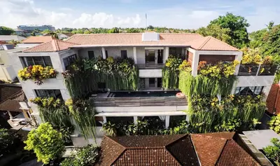 an aerial view of a building with tall trees at DUUR Apartments in Seminyak