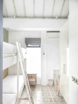 a room with bunk beds and a ladder at DUUR Apartments in Seminyak