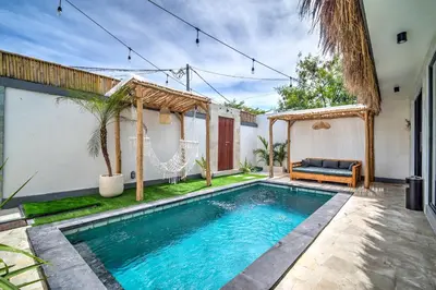 a swimming pool in the backyard of a house at Villa Esha III in Seminyak