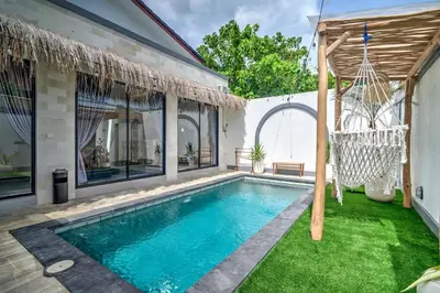a swimming pool in the backyard of a house at Villa Esha III in Seminyak