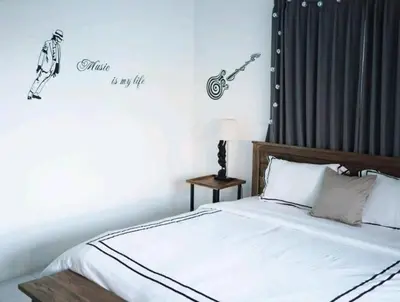a bedroom with a bed with a motorcycle on the wall at Villa Music in Seminyak