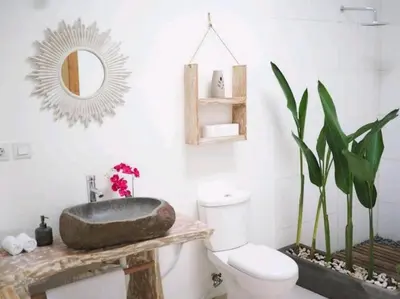 a bathroom with a sink and a toilet and a mirror at Villa Music in Seminyak