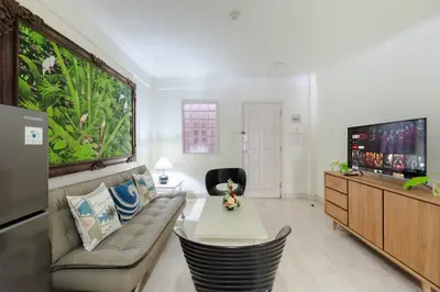 a living room with a couch and an aquarium at Private Apartment 6244 at Jayakarta Residence in Seminyak