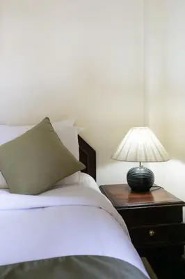 a bedroom with a bed with a lamp on a night stand at Private Apartment 6503 at the Jayakarta Residence in Seminyak