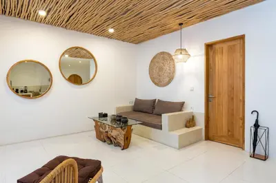 a living room with a couch and mirrors at Spacious 1Br Villas in Seminyak in Seminyak