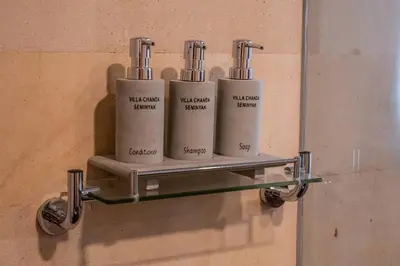 a wall mounted shelf with three bottles on it at Villa Cakka Seminyak in Seminyak