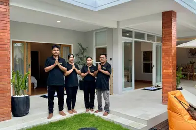 a group of people standing in front of a house at Villa Cakka Seminyak in Seminyak