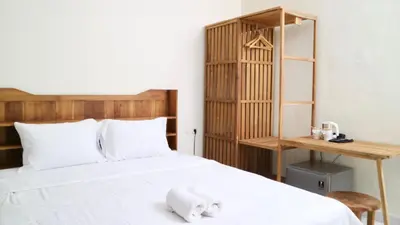 a bedroom with a bed with a stuffed animal on it at Puri Beach Inn - Poppies 2 in Legian