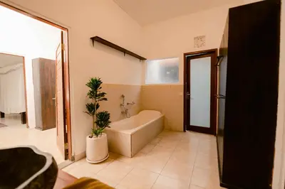 a bathroom with a tub and a plant in it at Amazing 2 Bedroom Villa 5 Min To The Beach - Durna Villa in Canggu