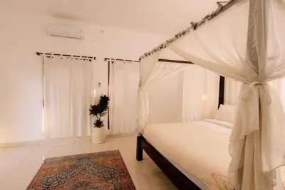 a bedroom with a canopy bed and a rug at Amazing 2 Bedroom Villa 5 Min To The Beach - Durna Villa in Canggu