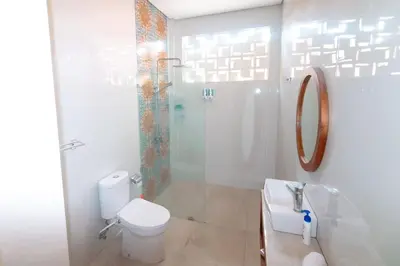 a bathroom with a toilet and a shower and a sink at Villa Shantia by Bby Diamond in Legian