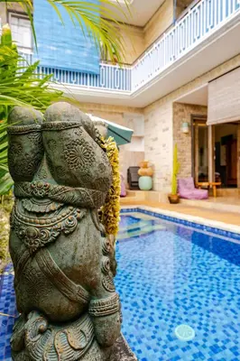 a statue sitting next to a swimming pool at Villa Naga, pool, Kitchen, terace and garden in Kerobokan