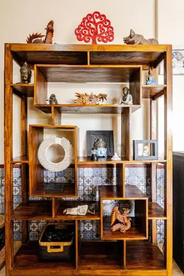 a wooden book shelf with photos and pictures at Villa Naga, pool, Kitchen, terace and garden in Kerobokan