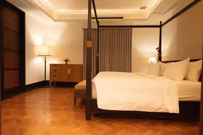 a hotel room with a bed and a dresser at 1BR Suite Ocean View in Seminyak