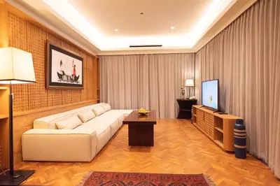 a living room with a white couch and a tv at 1BR Suite Ocean View in Seminyak