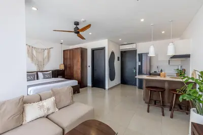 a living room with a bed and a kitchen at Sunny Aparts 2 in Canggu