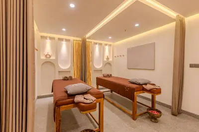 a hospital room with two beds and a mirror at Sunny Aparts 2 in Canggu