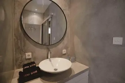 a bathroom with a white sink and a mirror at Elegant 5 Bdr villa in the heart of Seminyak in Seminyak