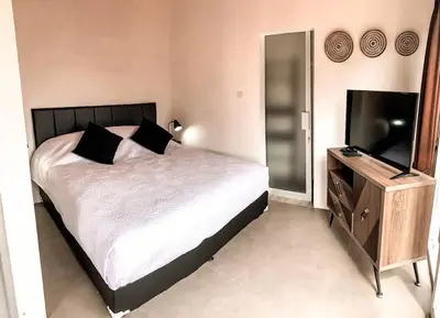 a bedroom with a bed and a flat screen tv at Elegant 5 Bdr villa in the heart of Seminyak in Seminyak