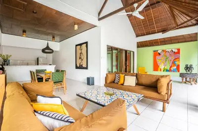 a living room with two couches and a table at Villa Amaro Seminyak in Seminyak