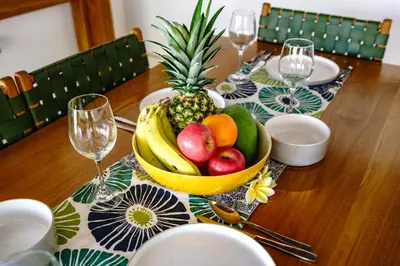 a wooden table with a bowl of fruit on it at Villa Amaro Seminyak in Seminyak