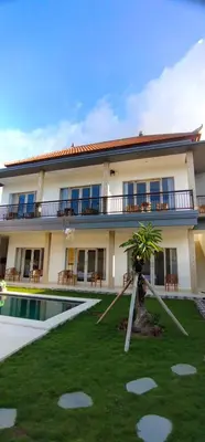 a villa with a swimming pool in front of it at The Lebak Sari Guesthouse in Umalas