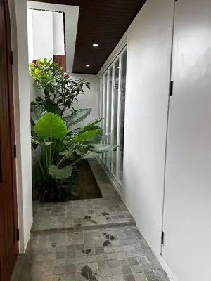 a hallway with a plant in a building at newly built Villa Na Bali in Seminyak