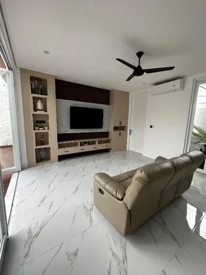a living room with a couch and a flat screen tv at newly built Villa Na Bali in Seminyak