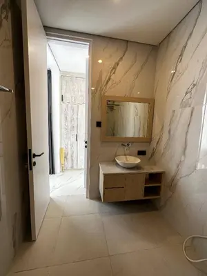 a bathroom with a sink and a mirror on the wall at newly built Villa Na Bali in Seminyak